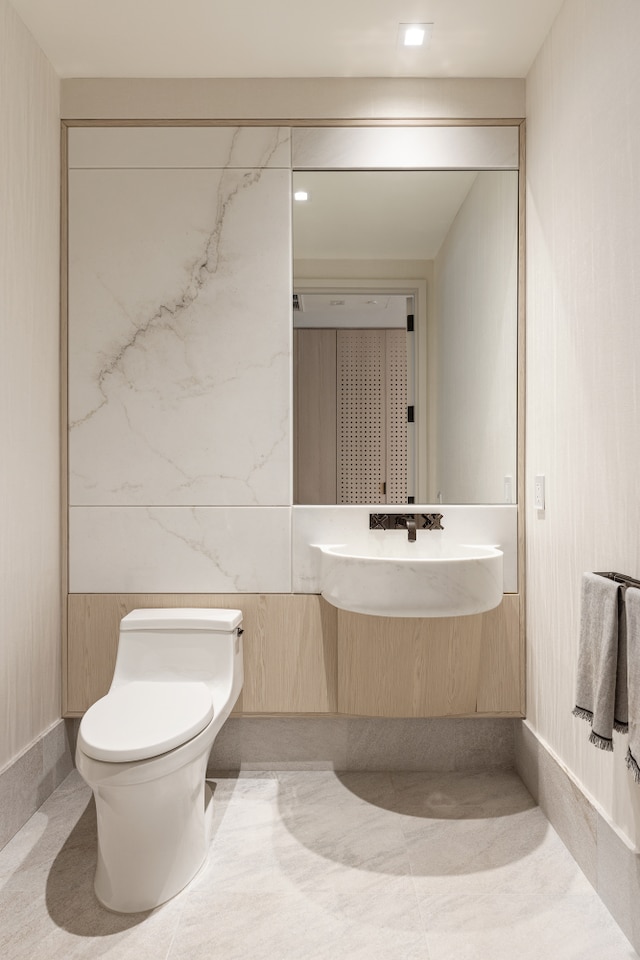 half bathroom featuring toilet and a sink