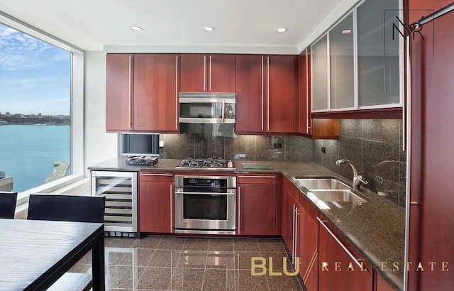 240 Riverside Blvd Unit 17-C, New York City, NY 10069 - kitchen with appliances with stainless steel finishes, wine cooler, granite tiled floors, a sink, and decorative backsplash