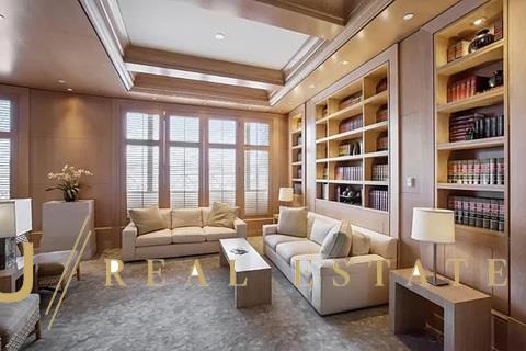 sitting room featuring built in shelves and crown molding