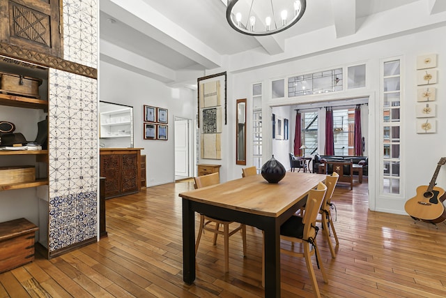 dining room featuring hardwood / wood-style flooring, beam ceiling, and french doors