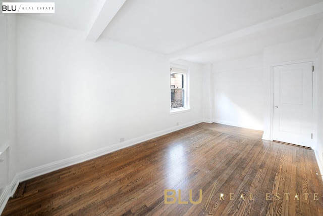 unfurnished room with baseboards, beam ceiling, and dark wood-type flooring