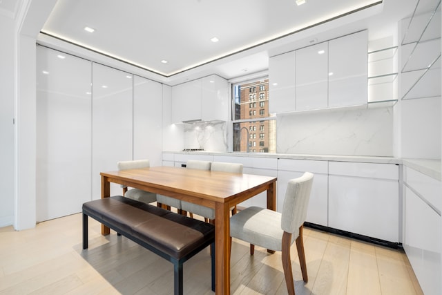 dining room featuring light wood finished floors and recessed lighting