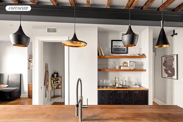 115 Milton St, New York City, NY 11222 - bar featuring visible vents, hanging light fixtures, a dry bar, wood finished floors, and baseboards