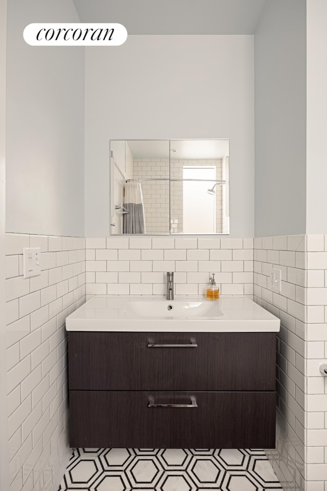 115 Milton St, New York City, NY 11222 - full bath with tile walls, a wainscoted wall, vanity, and a shower with shower curtain