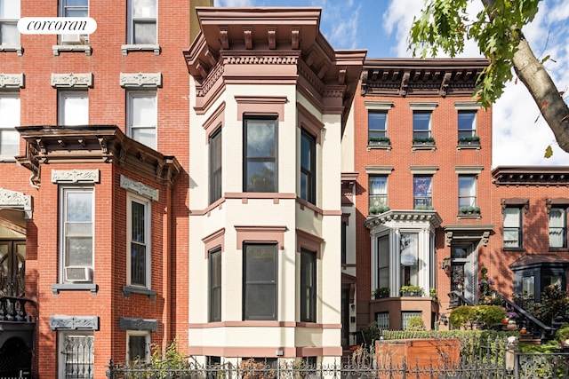 view of building exterior with fence