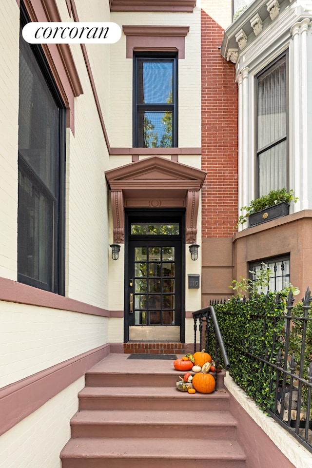 view of exterior entry with brick siding