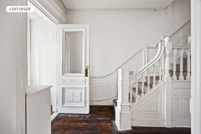 stairway featuring crown molding and hardwood / wood-style flooring