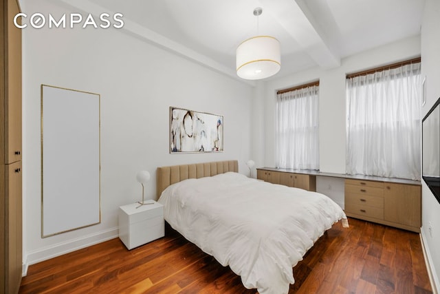 bedroom featuring baseboards, dark wood finished floors, and beamed ceiling