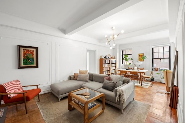 living area with a decorative wall, beamed ceiling, and a notable chandelier