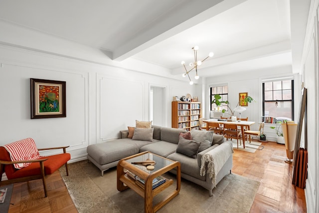 living area featuring an inviting chandelier, a decorative wall, and beam ceiling