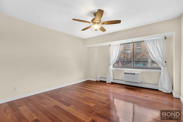 spare room featuring baseboards, a ceiling fan, wood finished floors, and baseboard heating
