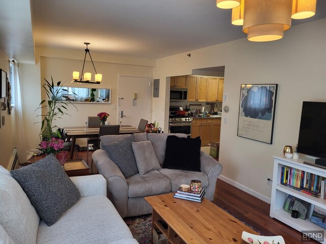 300 W 145th St Unit 1K, New York City, NY 10039 - living area featuring a chandelier, dark wood-style flooring, and baseboards