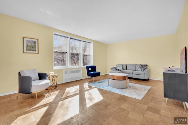 living room featuring radiator heating unit and baseboards