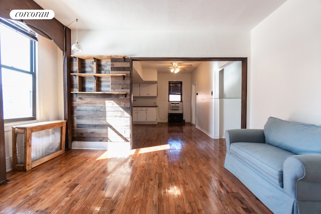 unfurnished living room with dark wood-type flooring and ceiling fan