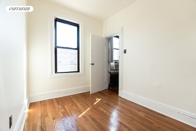 spare room featuring hardwood / wood-style flooring and cooling unit