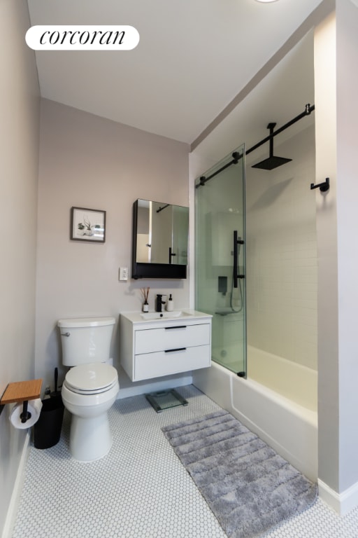 full bathroom featuring tiled shower / bath, vanity, tile patterned floors, and toilet