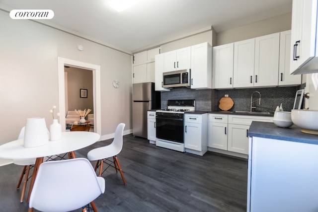 kitchen featuring white cabinetry, appliances with stainless steel finishes, sink, and tasteful backsplash