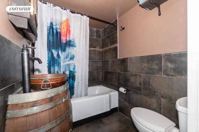 bathroom featuring shower / bath combo, tile walls, tile patterned floors, and toilet