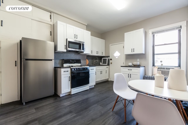 kitchen with white cabinetry, visible vents, appliances with stainless steel finishes, dark wood-style floors, and tasteful backsplash