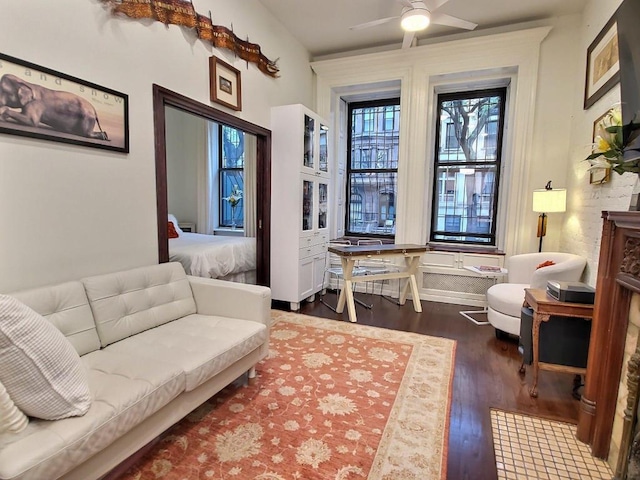 sitting room featuring dark hardwood / wood-style flooring and ceiling fan