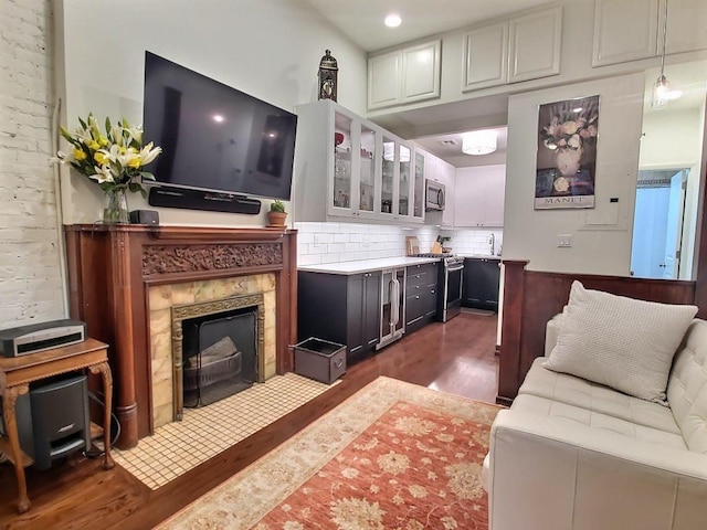 living room featuring dark wood-style floors, wine cooler, and a fireplace