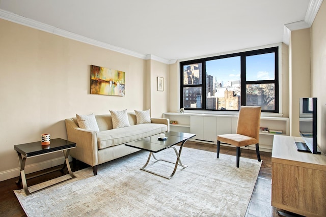 living area with ornamental molding, wood finished floors, and baseboards