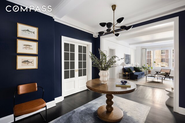 interior space with beamed ceiling, wood finished floors, crown molding, and a chandelier