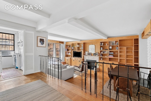 hallway featuring baseboards, beam ceiling, and wood finished floors