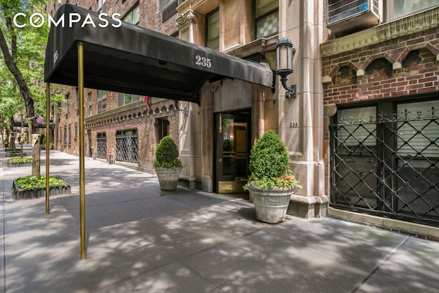 property entrance featuring brick siding
