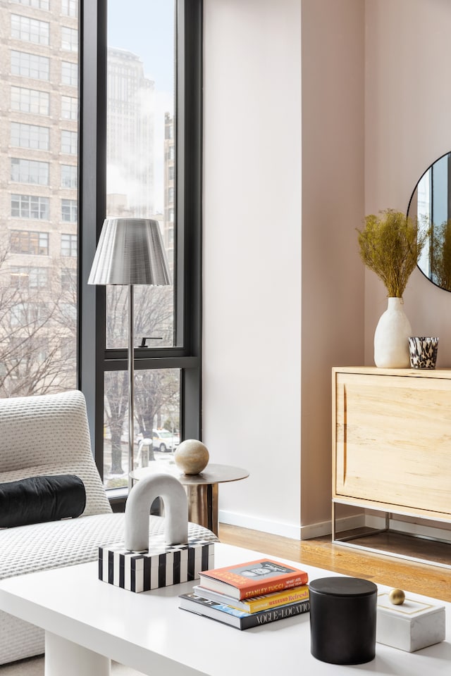 living area with a view of city, baseboards, and wood finished floors