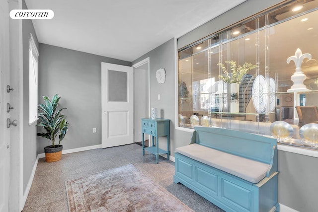 living area with visible vents, granite finish floor, and baseboards