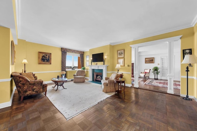 living room with decorative columns, a brick fireplace, and parquet flooring