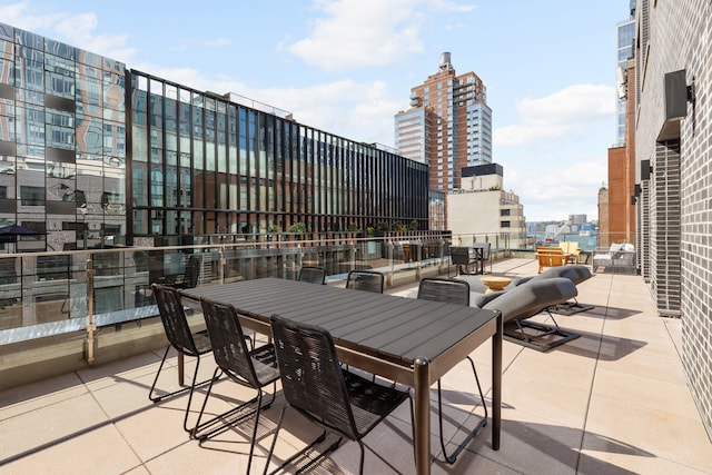 view of patio featuring outdoor dining area and a view of city