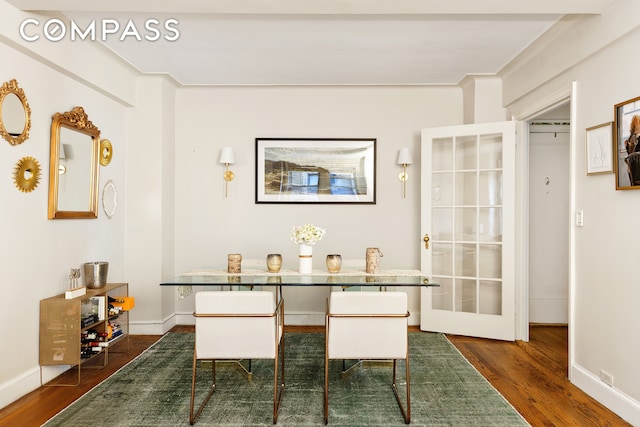 dining space with dark wood-style floors and baseboards