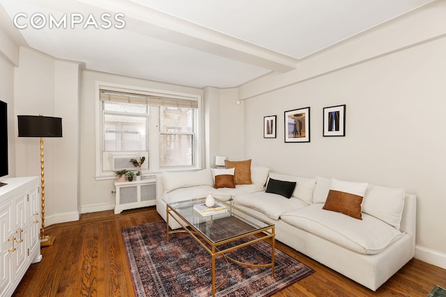 living room featuring radiator heating unit, baseboards, and wood finished floors