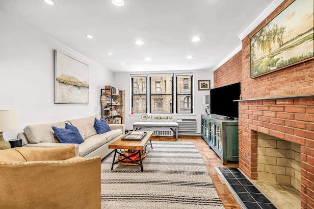 250 W 15th St Unit 1C, New York City, NY 10011 - living area featuring crown molding, recessed lighting, wood finished floors, and a brick fireplace