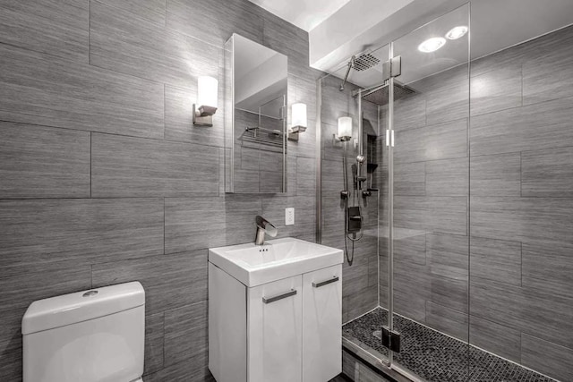 250 W 15th St Unit 1C, New York City, NY 10011 - bathroom featuring vanity, a stall shower, toilet, and tile walls