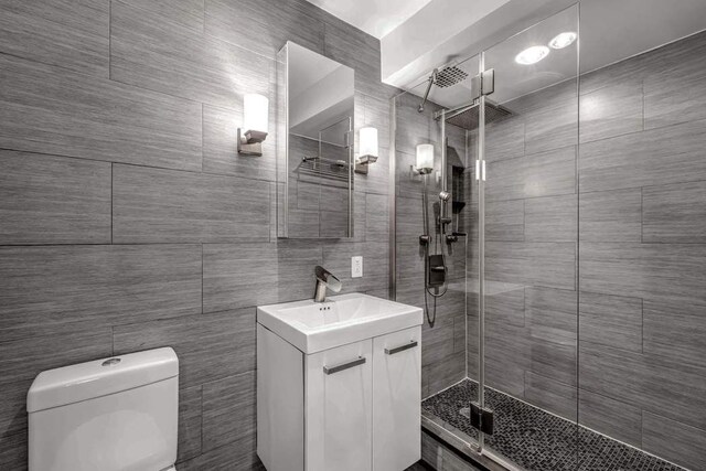 250 W 15th St Unit 1C, New York City, NY 10011 - bathroom with vanity, a shower stall, and tile walls