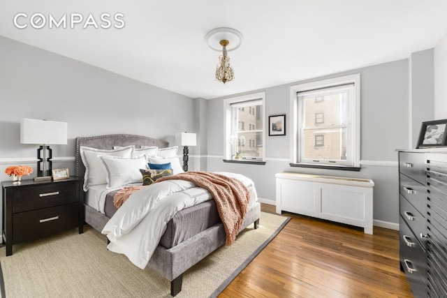 bedroom with dark hardwood / wood-style floors