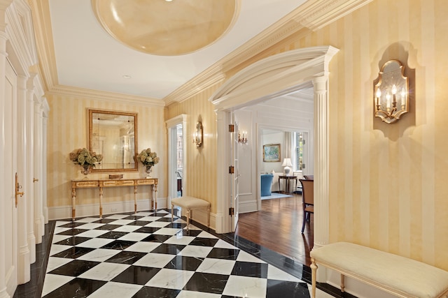 corridor featuring crown molding, ornate columns, baseboards, and wallpapered walls