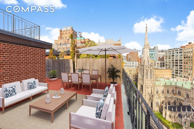 view of patio / terrace featuring a balcony, a view of city, and an outdoor hangout area