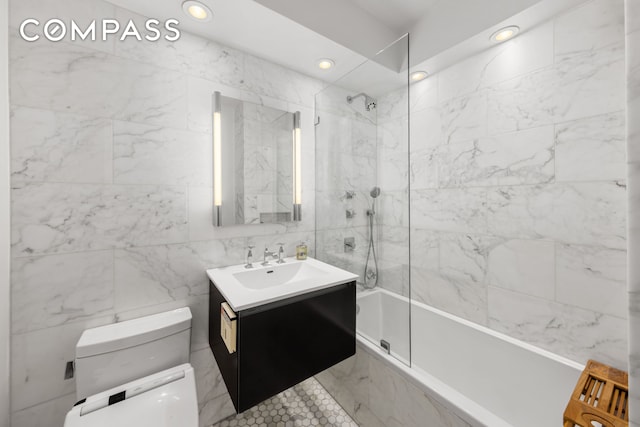 63 E 9th St Unit 14K, New York City, NY 10003 - bathroom with toilet, vanity, tiled shower / bath, recessed lighting, and tile walls