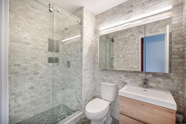 bathroom with backsplash, tile walls, vanity, walk in shower, and toilet