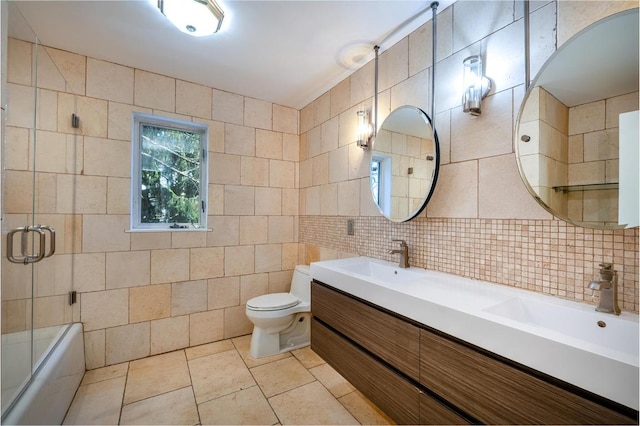 bathroom with tile walls, decorative backsplash, vanity, and toilet