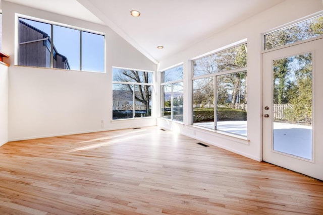 interior space with high vaulted ceiling and light hardwood / wood-style flooring