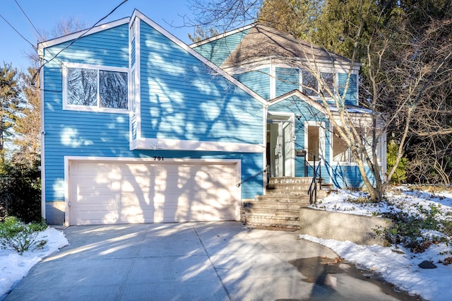 view of front of property featuring concrete driveway and a garage