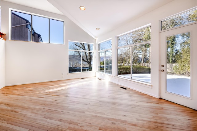 unfurnished sunroom with plenty of natural light and visible vents