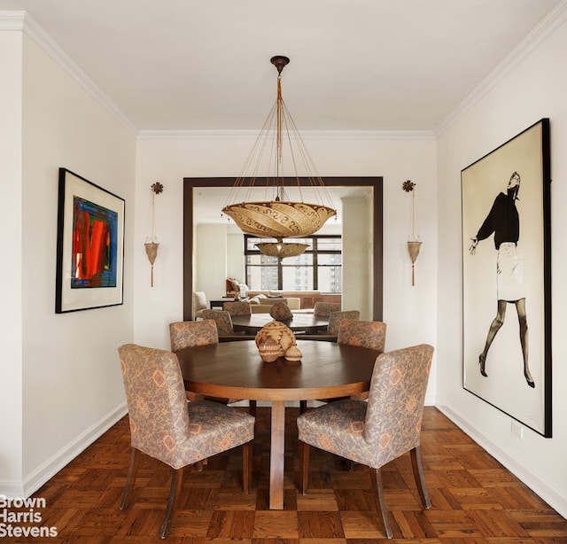 dining room with baseboards and crown molding