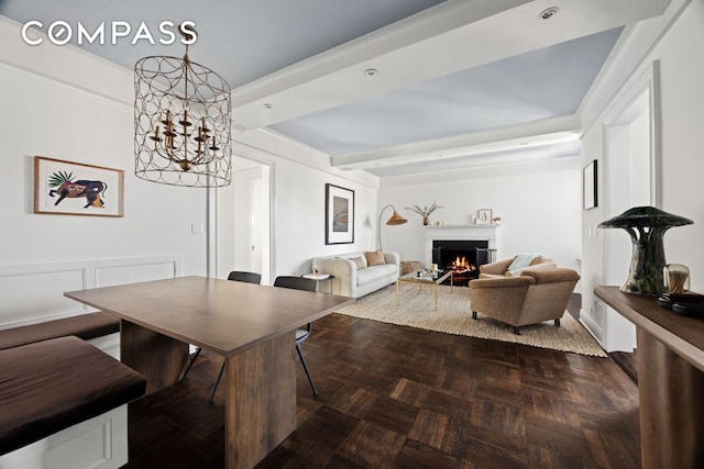 dining space with beam ceiling, a chandelier, and dark parquet floors