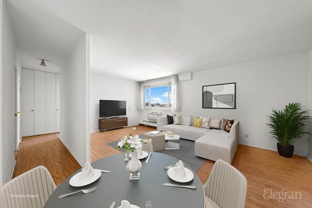 living area with baseboards and wood finished floors